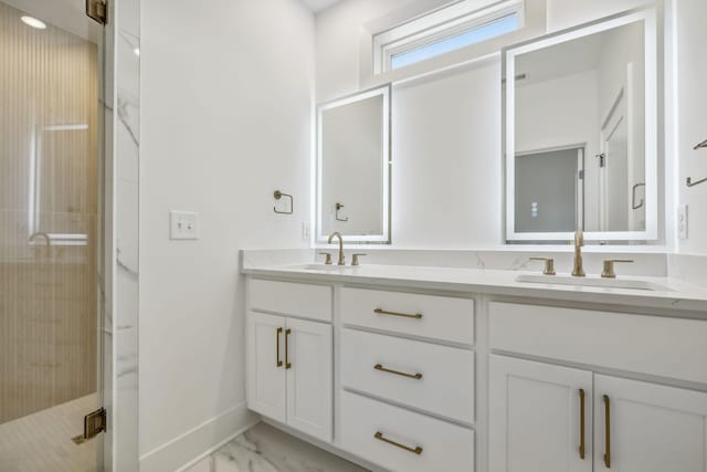 full bathroom with a sink, a shower stall, double vanity, and marble finish floor