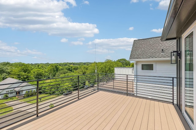 wooden deck with a wooded view