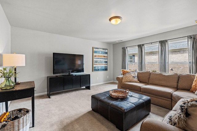 living room featuring baseboards and light colored carpet
