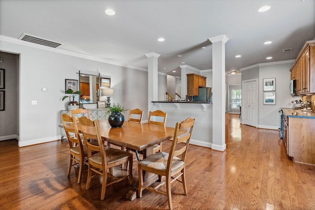 dining space featuring visible vents, ornamental molding, decorative columns, and recessed lighting