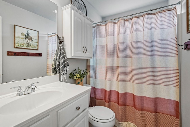 bathroom featuring vanity, toilet, and a shower with shower curtain