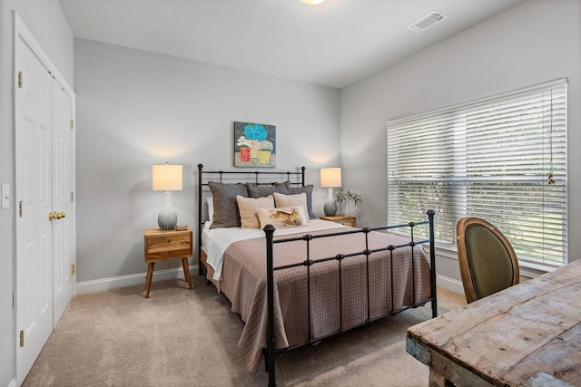 carpeted bedroom with baseboards and visible vents