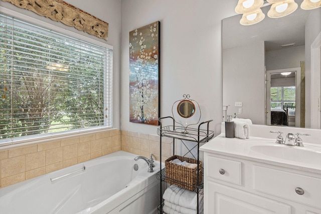 full bath with vanity, ensuite bathroom, and a bath
