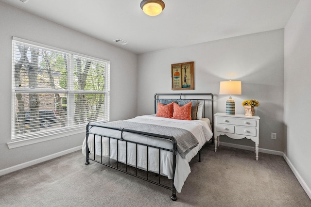 bedroom with visible vents, carpet flooring, and baseboards