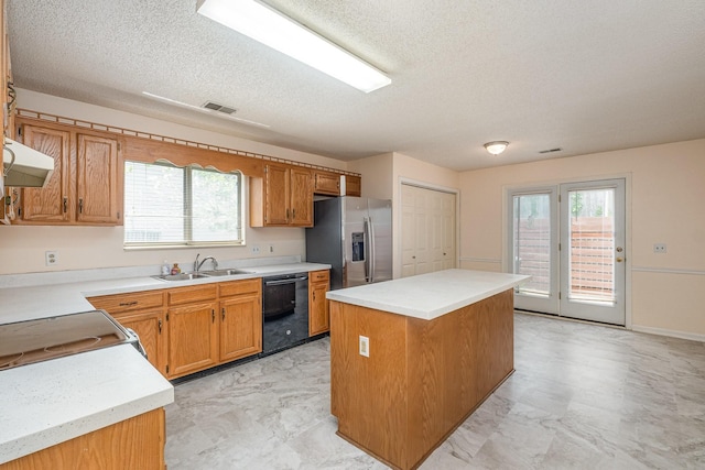 kitchen featuring stainless steel refrigerator with ice dispenser, a textured ceiling, visible vents, a sink, and black dishwasher