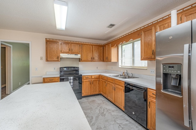 kitchen featuring under cabinet range hood, visible vents, black appliances, and light countertops
