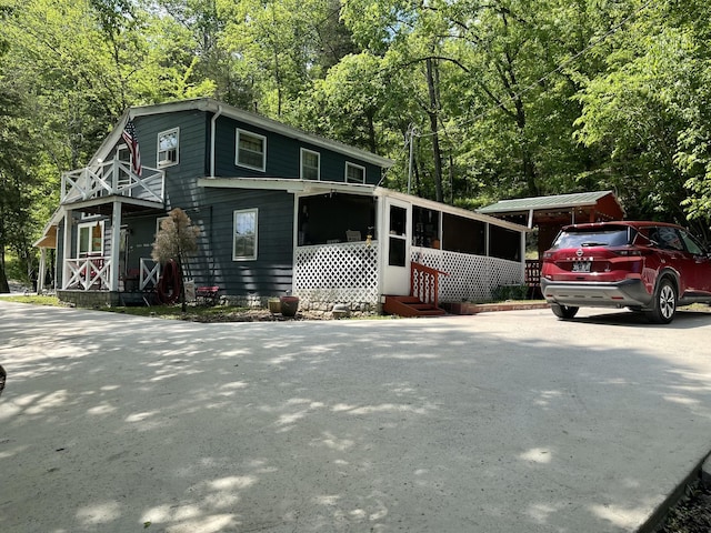 view of front of house with entry steps and a sunroom