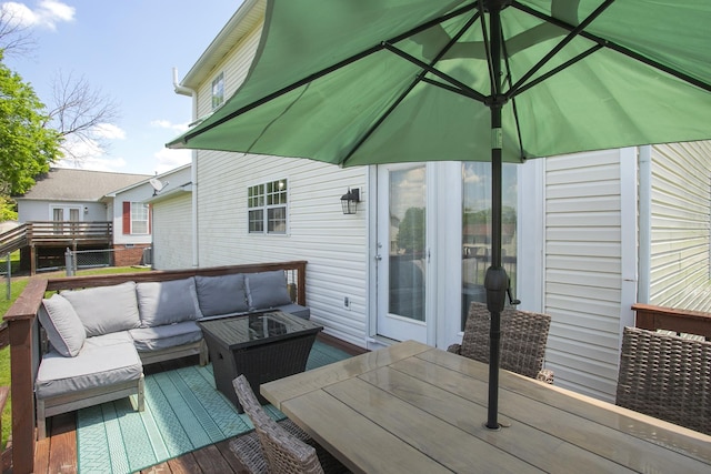 wooden terrace with outdoor dining area and an outdoor hangout area