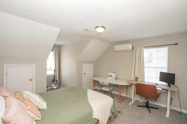 carpeted bedroom with an AC wall unit, a textured ceiling, vaulted ceiling, and baseboards