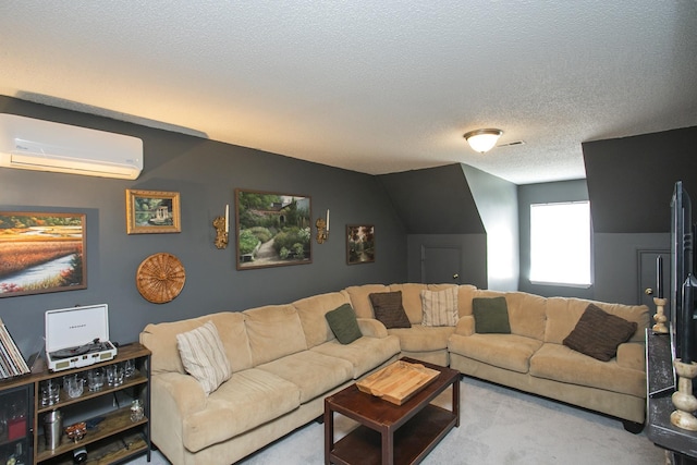 living area featuring carpet floors, a wall mounted air conditioner, and a textured ceiling