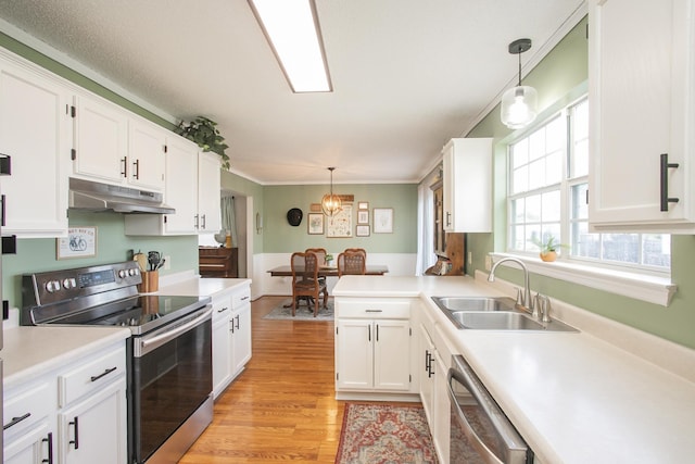 kitchen featuring a sink, appliances with stainless steel finishes, under cabinet range hood, and white cabinetry