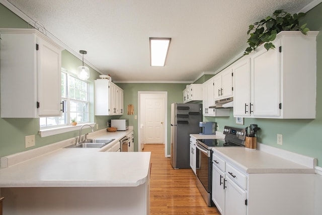 kitchen featuring a sink, under cabinet range hood, white cabinets, and stainless steel appliances