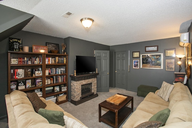 carpeted living room featuring visible vents, a textured ceiling, and a stone fireplace