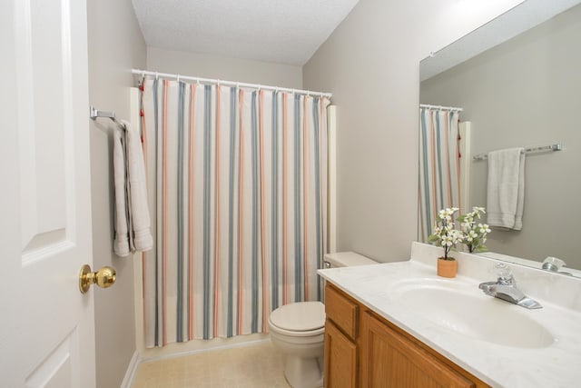bathroom with vanity, a shower with curtain, toilet, and a textured ceiling