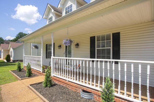 view of exterior entry featuring covered porch