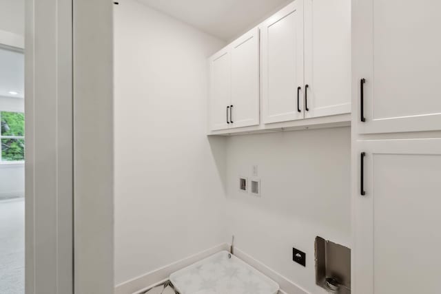 washroom with baseboards, hookup for an electric dryer, hookup for a washing machine, and cabinet space