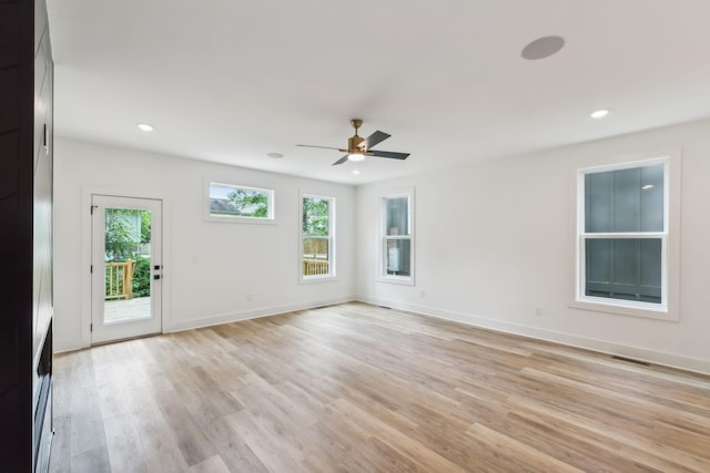 spare room with recessed lighting, light wood finished floors, ceiling fan, and a wealth of natural light