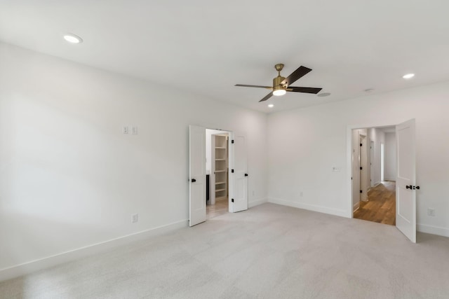 unfurnished bedroom featuring baseboards, ceiling fan, light carpet, and recessed lighting