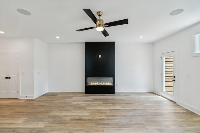 unfurnished living room featuring a fireplace, recessed lighting, a ceiling fan, and light wood-type flooring