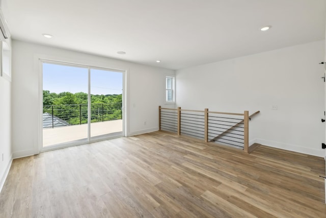 empty room featuring baseboards, recessed lighting, and light wood-style flooring