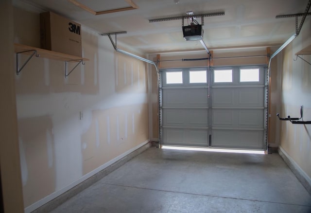 319 Mattie Ln, Spring Hill, TN 37174 - garage featuring baseboards and a garage door opener
