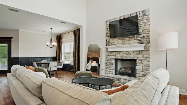 1210 Macey Peri Way, Smyrna, TN 37167 - living room with a chandelier, dark wood-style flooring, healthy amount of natural light, ornamental molding, and a stone fireplace