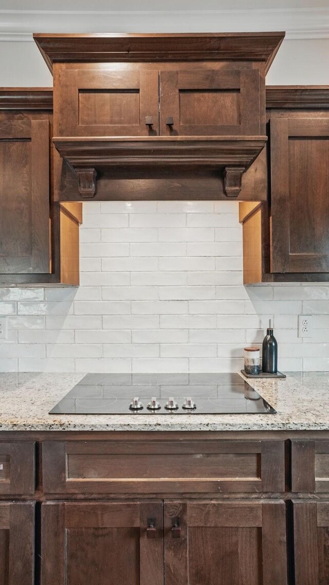 1210 Macey Peri Way, Smyrna, TN 37167 - kitchen with backsplash, dark brown cabinets, black electric cooktop, and light stone countertops