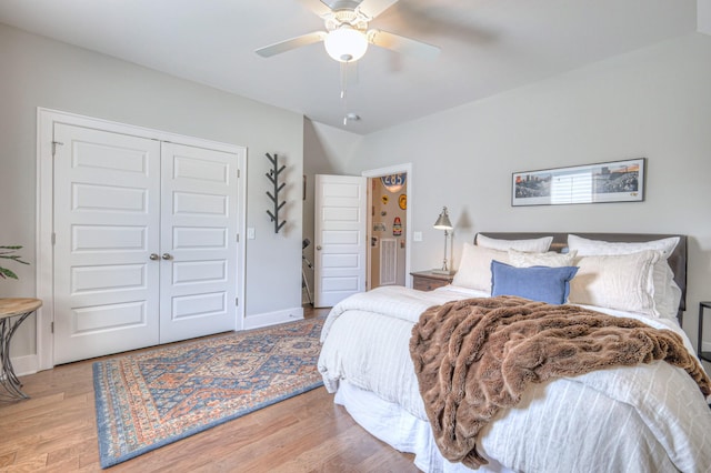 bedroom featuring a closet, baseboards, ceiling fan, and light wood-type flooring