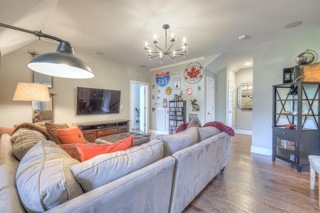 living room with baseboards, an inviting chandelier, and wood finished floors