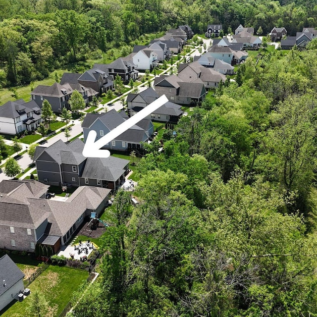 birds eye view of property with a view of trees and a residential view