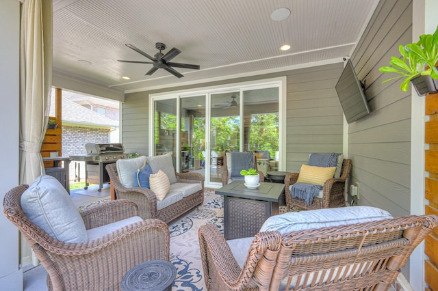 view of patio / terrace with area for grilling, ceiling fan, and an outdoor living space