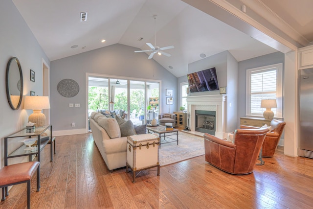 living area featuring ceiling fan, plenty of natural light, and light wood finished floors