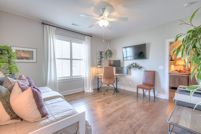 living area with plenty of natural light, wood finished floors, and visible vents