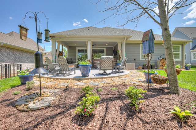 rear view of house featuring a patio, a ceiling fan, roof with shingles, and fence