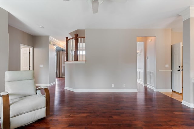 unfurnished room featuring ceiling fan, visible vents, baseboards, and hardwood / wood-style flooring