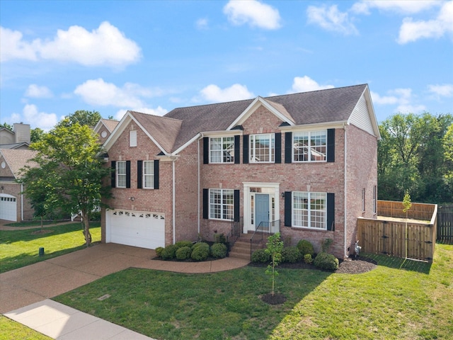 view of front facade featuring a garage, a front lawn, fence, brick siding, and driveway