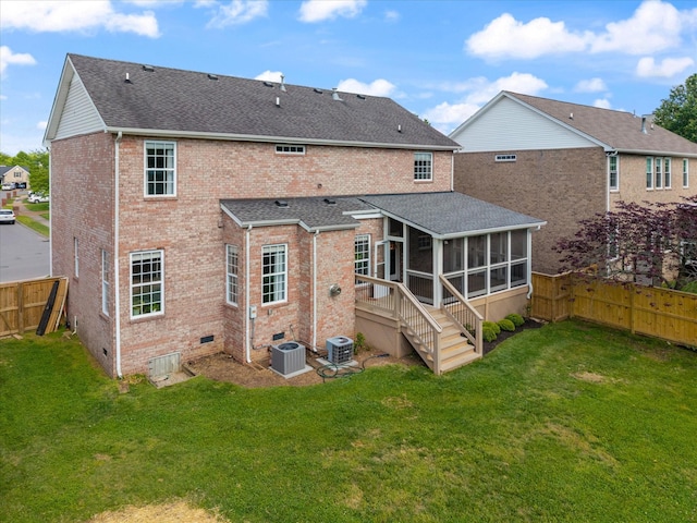 rear view of property with central air condition unit, roof with shingles, brick siding, and a sunroom