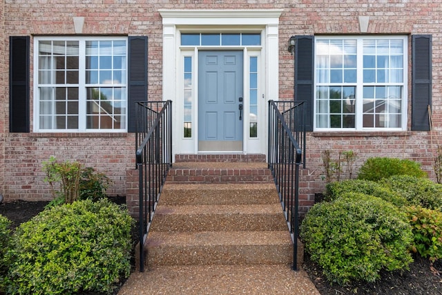 property entrance featuring brick siding