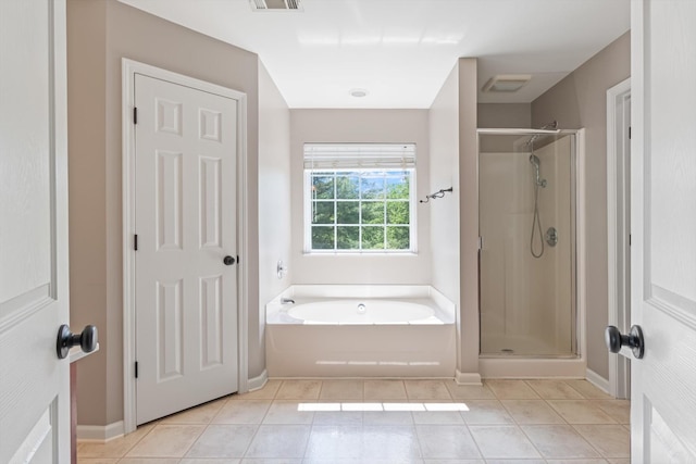 bathroom featuring baseboards, tile patterned flooring, a stall shower, and a bath
