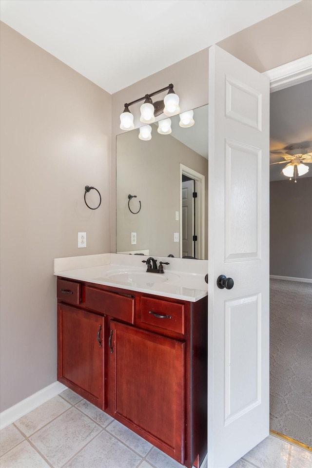 bathroom with ceiling fan, baseboards, tile patterned floors, and vanity
