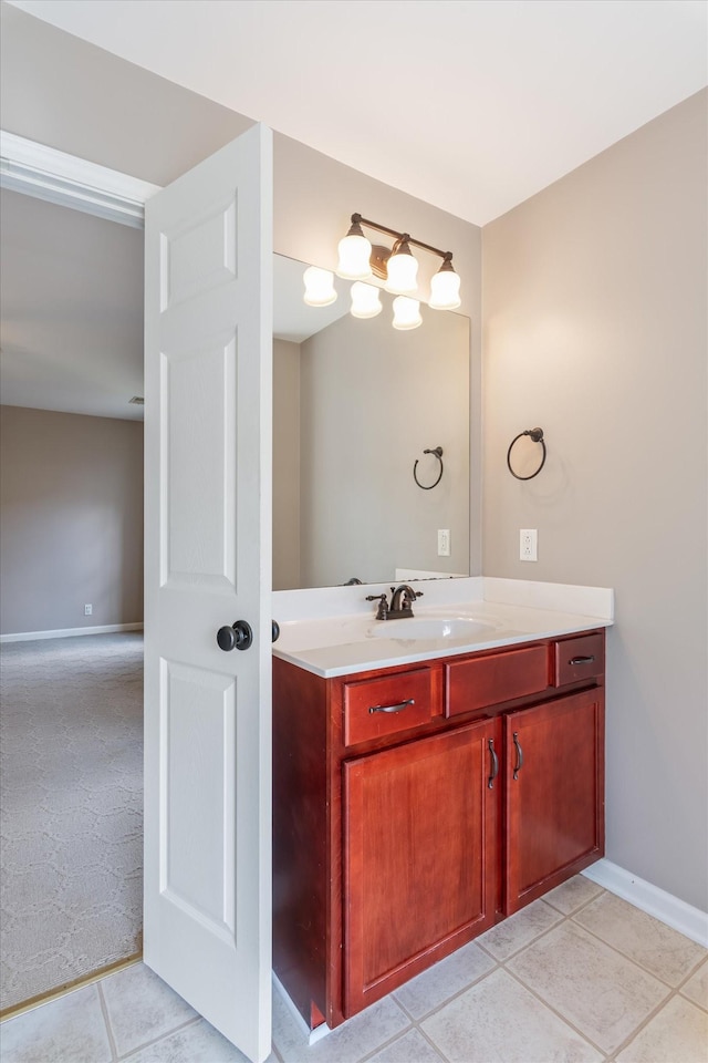 bathroom featuring vanity, baseboards, and tile patterned floors
