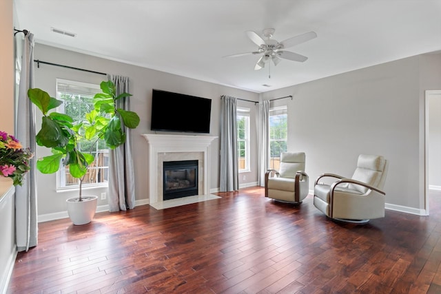 sitting room featuring baseboards, a ceiling fan, wood finished floors, and visible vents