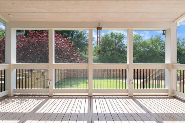 unfurnished sunroom with wooden ceiling and hardwood / wood-style floors
