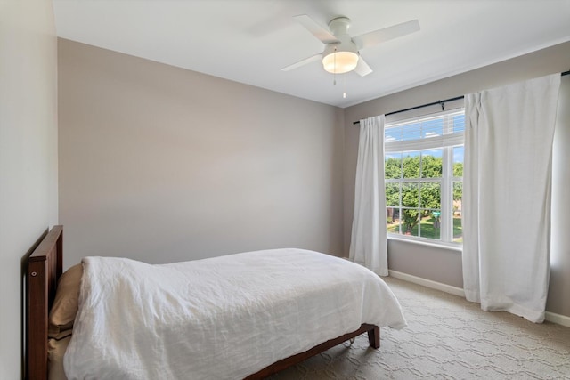 carpeted bedroom with baseboards and ceiling fan