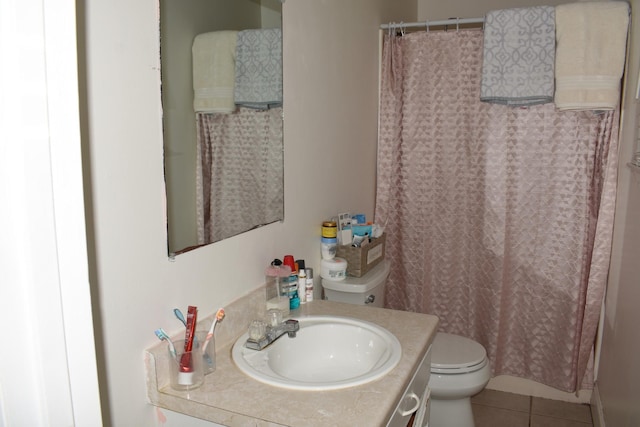 bathroom with vanity, tile patterned floors, toilet, and curtained shower
