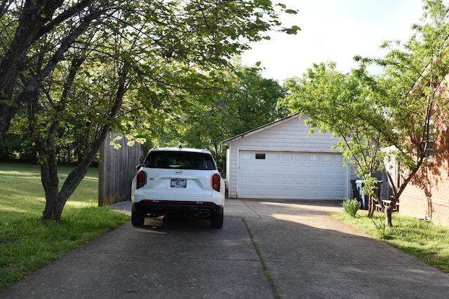 garage featuring concrete driveway