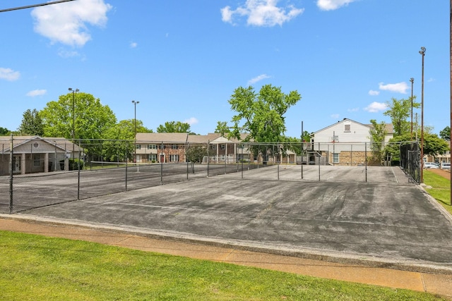 surrounding community featuring fence and a tennis court