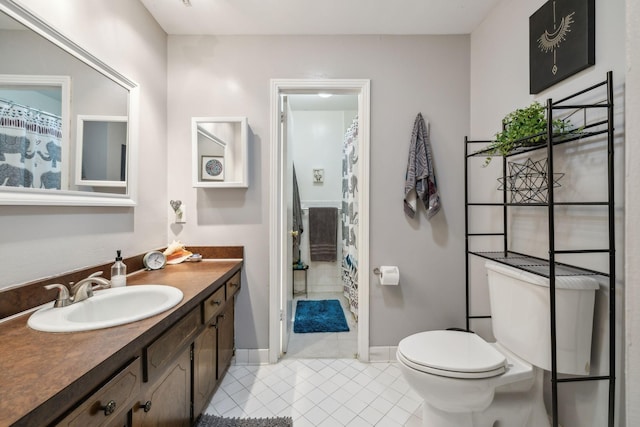 bathroom with tile patterned flooring, vanity, toilet, baseboards, and a shower with shower curtain