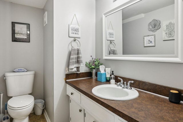half bath featuring vanity and toilet