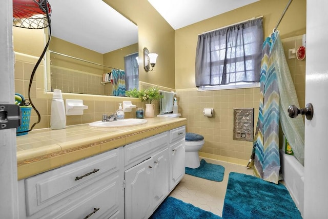 418 Mason Ln, Goodlettsville, TN 37072 - bathroom featuring tile walls, toilet, vanity, tile patterned floors, and a wainscoted wall